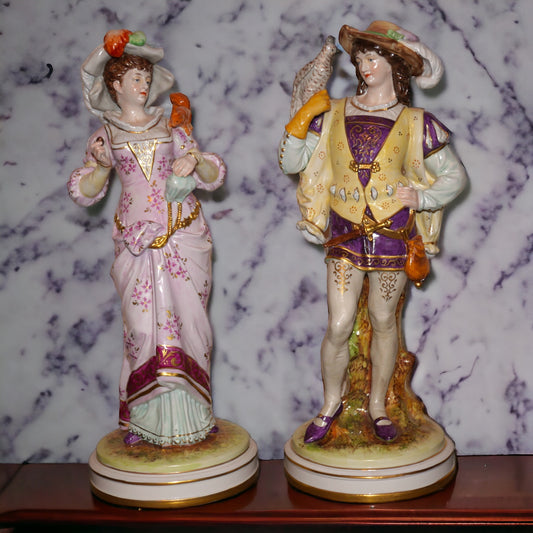 Set of 2 Circa 1930 German Kister Porcelain Victorian 19th Century Style Male Falconer and Woman Feeding Squirrel Figurines