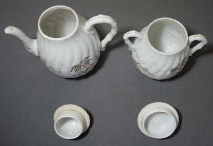 Circa 1920 Japanese Kutani Porcelain Hand Painted Village Motifs Bamboo Handled Teapot and Lidded Sugar Bowl Set (Taisho Period)