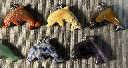 Lot of 11 Carved Polished Natural Gemstone, Crystal, and Art Glass Composite Dolphin Jewelry Pendants