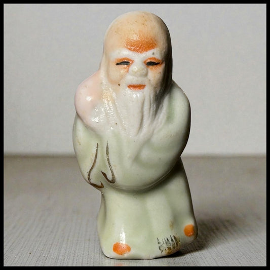 Circa Mid 19th Century Japanese Celadon Glazed Porcelain Fukurokuju Miniature Netsuke Figurine