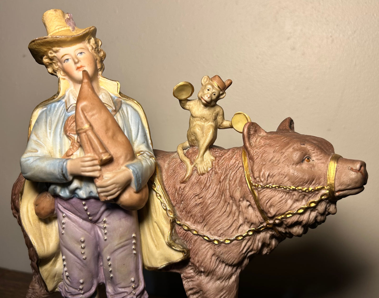 Circa 1930 German Scheibe-Alsbach Kister Bisque Porcelain Man with Bagpipes/Monkey with Cymbals Atop Grizzly Bear Figural Group