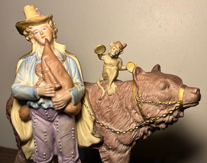 Circa 1930 German Scheibe-Alsbach Kister Bisque Porcelain Man with Bagpipes/Monkey with Cymbals Atop Grizzly Bear Figural Group
