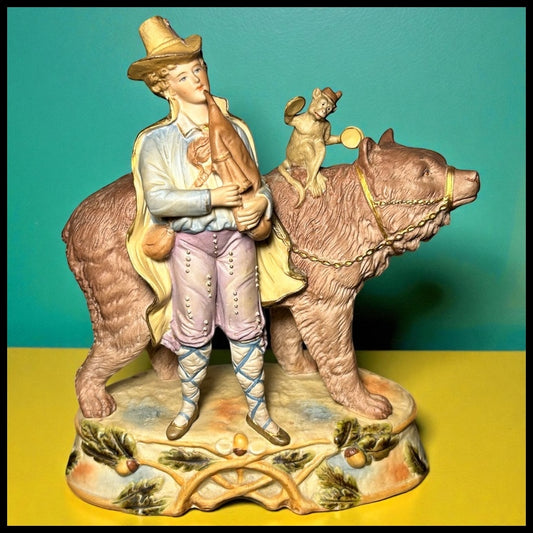 Circa 1930 German Scheibe-Alsbach Kister Bisque Porcelain Man with Bagpipes/Monkey with Cymbals Atop Grizzly Bear Figural Group