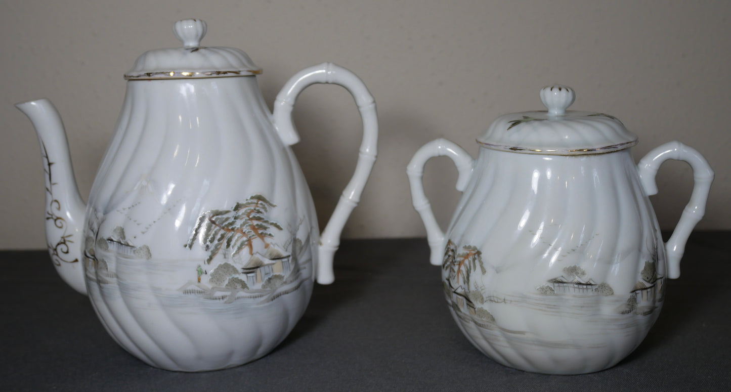 Circa 1920 Japanese Kutani Porcelain Hand Painted Village Motifs Bamboo Handled Teapot and Lidded Sugar Bowl Set (Taisho Period)
