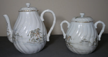 Circa 1920 Japanese Kutani Porcelain Hand Painted Village Motifs Bamboo Handled Teapot and Lidded Sugar Bowl Set (Taisho Period)