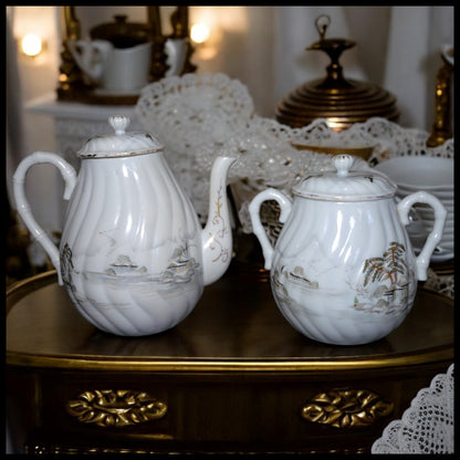 Circa 1920 Japanese Kutani Porcelain Hand Painted Village Motifs Bamboo Handled Teapot and Lidded Sugar Bowl Set (Taisho Period)