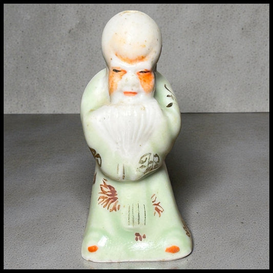 Circa Mid 19th Century Japanese Celadon Glazed Porcelain Fukurokuju Miniature Netsuke Figurine