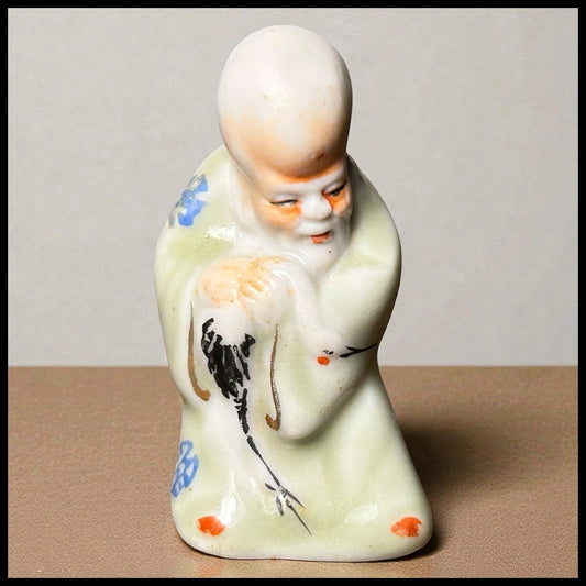 Circa Mid 19th Century Japanese Celadon Glazed Porcelain Fukurokuju Miniature Netsuke Figurine