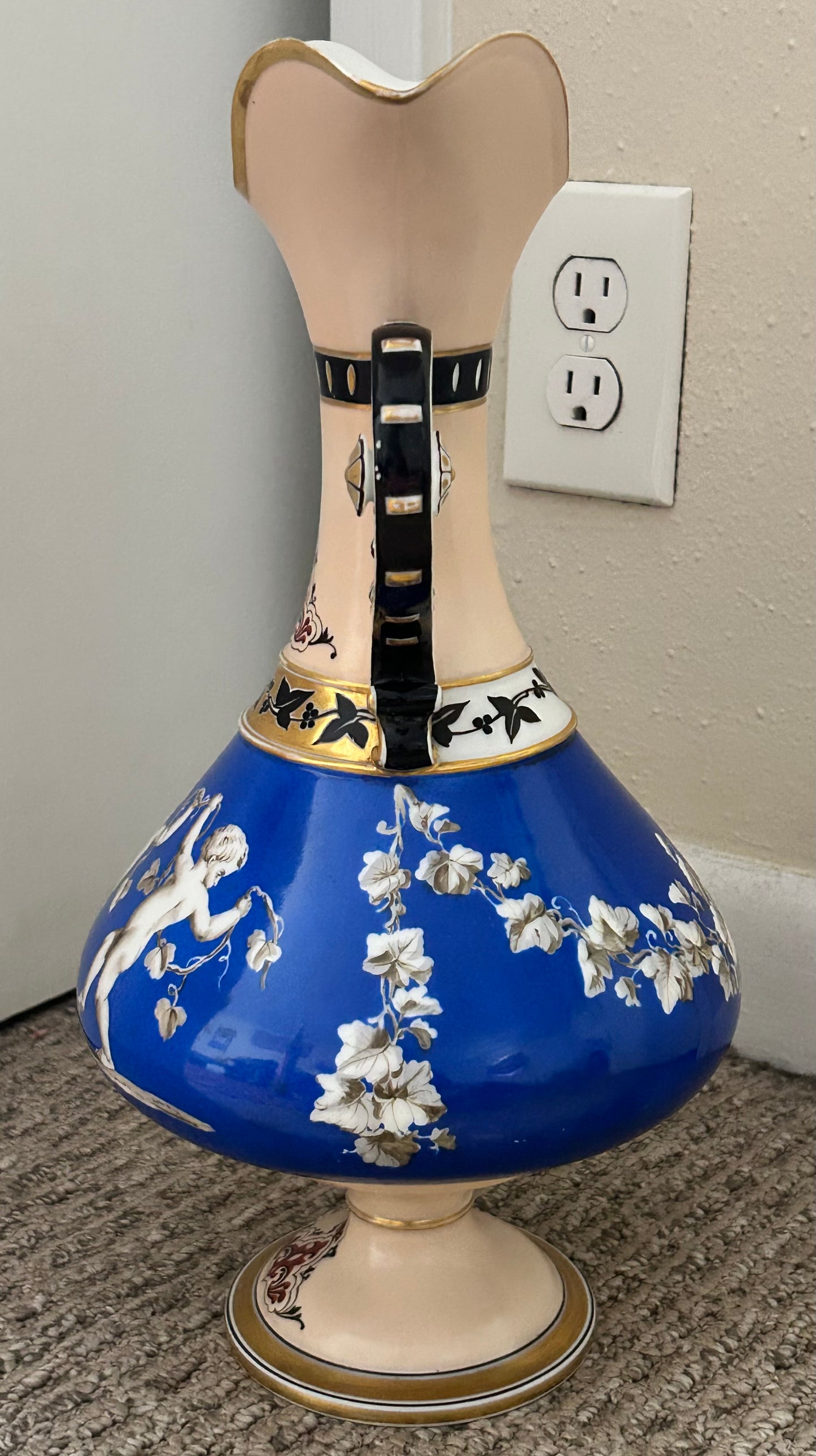 Mid 19th Century French Rococo Revival Porcelain Hand-Painted Gilded Bacchanal Putti Holding Vine Motif Double-Handled Footed Baluster Vase